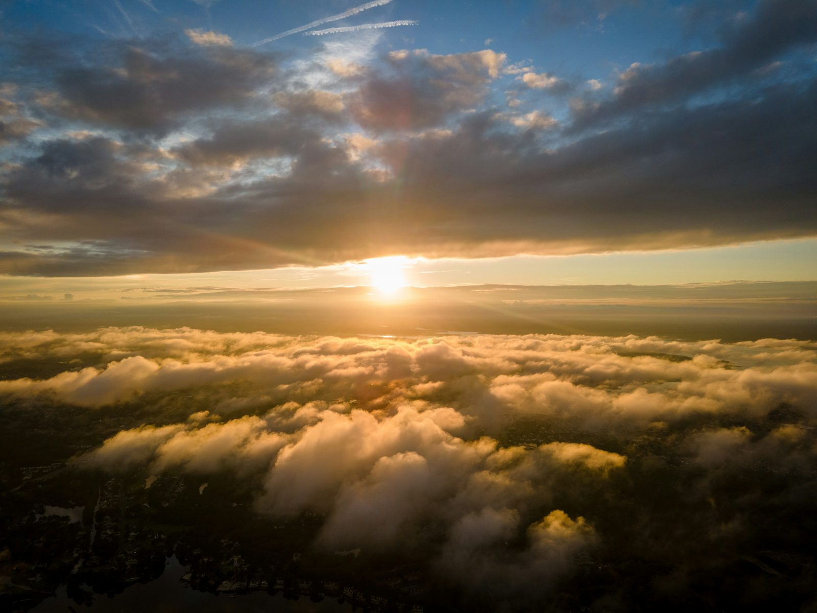 The sun rising over a bank of clouds, seen from the Bethany Beach coast